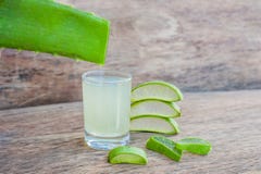 Aloe vera pieces and aloe gel in the glass on an old dark wood background Organic cosmetics concept royalty free stock photos Aloe vera pieces and aloe gel in the glass on an old dark wood background Organic cosmetics concept royalty free stock photos