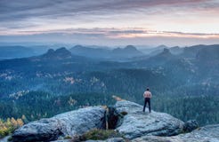 Alone athletic naked man, tourist, climbed up rocky hill. Wild landscape. stock images Alone athletic naked man, tourist, climbed up rocky hill. Wild landscape. stock images