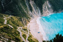 Alone tourist tent on famous Myrtos Beach. Big foam waves rolling towards the bay. Kefalonia, Greece stock photos Alone tourist tent on famous Myrtos Beach. Big foam waves rolling towards the bay. Kefalonia, Greece stock photos