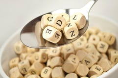 Alphabet soup with cubes dice and spoon stock photography Alphabet soup with cubes dice and spoon stock photography