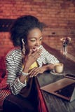 Amazed Afro-American woman covering mouth in shock at bar stock image Amazed Afro-American woman covering mouth in shock at bar stock image