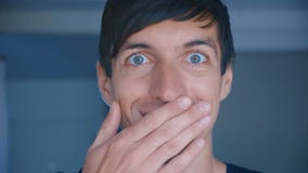 Amazed and shocked male face. Surprised handsome man saying wow and smiling to camera at home indoor. stock video footage Amazed and shocked male face. Surprised handsome man saying wow and smiling to camera at home indoor. stock video footage