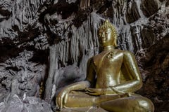 Amazing Gold Buddha Statue In Beautiful Cave, Holy Natural Buddhist Sanctuary In Thailand Stock Image