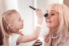 Amazing Little Girl Making Makeup To Her Grandmother Stock Photography Amazing Little Girl Making Makeup To Her Grandmother Stock Photography