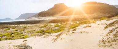 Amazing sunset over volcanic mountains on desolated atlantic coast. Sunrays falling on coastal dunes Sao Vicente Cape Royalty Free Stock Image Amazing sunset over volcanic mountains on desolated atlantic coast. Sunrays falling on coastal dunes Sao Vicente Cape Royalty Free Stock Image