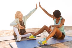 Amazing young two sports women gives a high-five to each other. stock photos Amazing young two sports women gives a high-five to each other. stock photos