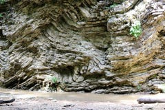 Layers of frozen magma on millions of years on the bank of a mountain stream stock image Layers of frozen magma on millions of years on the bank of a mountain stream stock image