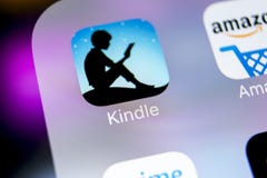 Amazon Kindle application icon on Apple iPhone X screen close-up. Amazon Kindle app icon. Amazon kindle application. Social media royalty free stock images Amazon Kindle application icon on Apple iPhone X screen close-up. Amazon Kindle app icon. Amazon kindle application. Social media royalty free stock images