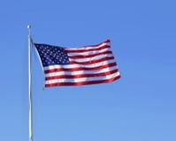 American flag flying ion blue sky background. Stock Photo American flag flying ion blue sky background. Stock Photo