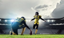 American football players at arena . Mixed media stock photo American football players at arena . Mixed media stock photo