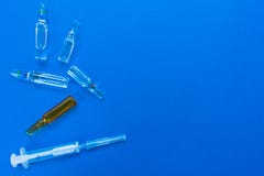 Ampoules et seringue pour l'injection Drogues médicales sur un fond bleu Disposition plate, photo stock Ampoules et seringue pour l'injection Drogues médicales sur un fond bleu Disposition plate, photo stock