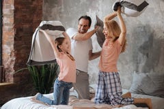 Amused family enjoying pillow fight at home royalty free stock image Amused family enjoying pillow fight at home royalty free stock image
