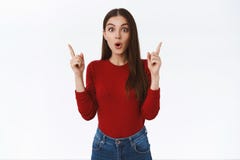 Amused, interested and curious young brunette feminine woman in red sweater, open mouth wondered, gasping fascinated say