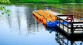 Amusement park. water bikes on the background of the water surface of the pond. Landscape royalty free stock image Amusement park. water bikes on the background of the water surface of the pond. Landscape royalty free stock image