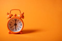 Analogue clock on orange background stock image Analogue clock on orange background stock image