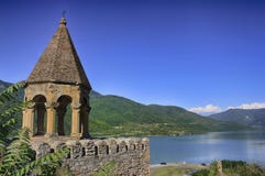 Ancient castle in the mountains over the lake. Sunny summer day stock photography Ancient castle in the mountains over the lake. Sunny summer day stock photography