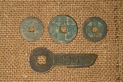 Ancient Chinese Bronze Coins On Old Cloth Stock Photos