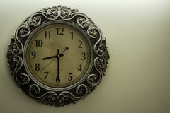 Ancient Designer Wall Clock With Light Yellow Back Ground showing time 08:30 o`clock and free spac on right side