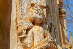 An ancient stone idol tells its stories to rare guests on the ruins in Myanmar