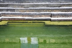 An ancient pond made with stone and having green water situated at Kurnool, Andhra Pradesh in India.