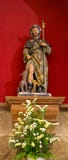 Ancient statue of Saint James with stick and dogs and flowers. Patron of pilgrims. Symbol of Camino de Santiago. royalty free stock photo Ancient statue of Saint James with stick and dogs and flowers. Patron of pilgrims. Symbol of Camino de Santiago. royalty free stock photo