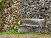 Ancient stone bench along a castle wall stock photos Ancient stone bench along a castle wall stock photos