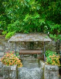Ancient well surrounded by colorful flowers in Rochefort-en-Terre, French Brittany royalty free stock image Ancient well surrounded by colorful flowers in Rochefort-en-Terre, French Brittany royalty free stock image