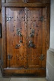 Ancient wooden sacristy door with skull and snake on door mounting, Saint Michael Church Schwabisch Hall, Germany