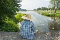 Angling boy with fishing rod on concrete bridge back view royalty free stock images Angling boy with fishing rod on concrete bridge back view royalty free stock images