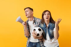 Angry expessive crazy couple, woman man football fans screaming, upset of loss, goal of favorite team with soccer ball stock photography Angry expessive crazy couple, woman man football fans screaming, upset of loss, goal of favorite team with soccer ball stock photography