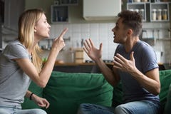 Angry millennial couple arguing shouting blaming each other of p