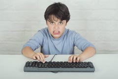 Angry and stressed child with keyboard royalty free stock image Angry and stressed child with keyboard royalty free stock image