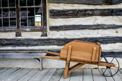 Antique Wooden Wheelbarrow, Log Cabin Stock Photography Antique Wooden Wheelbarrow, Log Cabin Stock Photography