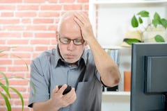 An anxious man looks at his smartphone stock photos An anxious man looks at his smartphone stock photos