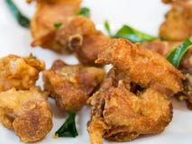 Appetizer fried chicken with crispy skin served with crunchy kaffir lime leaves add texture and fragrant that is full of Thai curr stock photo Appetizer fried chicken with crispy skin served with crunchy kaffir lime leaves add texture and fragrant that is full of Thai curr stock photo
