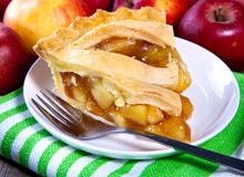 Apple Pie Slice. Plate of apple pie with fresh apples in the background - Horizontal Apple Pie Slice. Plate of apple pie with fresh apples in the background - Horizontal