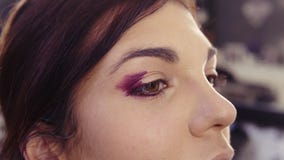 Applicando l'eye-liner porpora nell'angolo esterno e nella piega esterna per creare gli occhi affumicati perfetti guardano Caucas archivi video Applicando l'eye-liner porpora nell'angolo esterno e nella piega esterna per creare gli occhi affumicati perfetti guardano Caucas archivi video