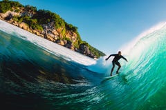 April 18, 2019. Bali, Indonesia. Surfer ride on barrel wave. Professional surfing at big waves in Padang Padang royalty free stock images April 18, 2019. Bali, Indonesia. Surfer ride on barrel wave. Professional surfing at big waves in Padang Padang royalty free stock images