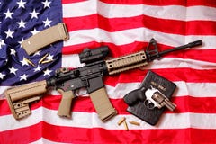 AR Rifle, A Bible & A Pistol On American Flag Royalty Free Stock Images