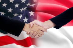 Arbetarhandskakning med amerikan- och indonesflaggorna arkivbild Arbetarhandskakning med amerikan- och indonesflaggorna arkivbild
