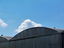 Arched Aluminum Clad Hangar Building Top Detail With Blue Sky Royalty Free Stock Photo