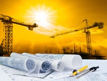 Architect plan on working table with crane and building construction background