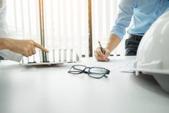 Architects engineer discussing at the table with blueprint - Closeup on hands and project print, Team group on construciton site royalty free stock image Architects engineer discussing at the table with blueprint - Closeup on hands and project print, Team group on construciton site royalty free stock image
