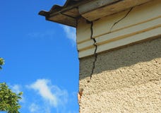 Architecture detail of damaged house corner dilapidated old building facade wall over blue sky background. stock photography Architecture detail of damaged house corner dilapidated old building facade wall over blue sky background. stock photography