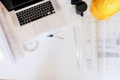 Architecture drawing desk,Business,engineering concept,construction site working with blueprints in the office top view. stock image Architecture drawing desk,Business,engineering concept,construction site working with blueprints in the office top view. stock image