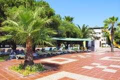 The architecture of the Turkish hotel with sun loungers, palm trees and people relaxing in the summer royalty free stock photos The architecture of the Turkish hotel with sun loungers, palm trees and people relaxing in the summer royalty free stock photos
