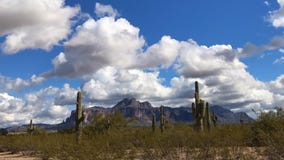 Arizona desert landscape with fluffy white clouds. Passing by. Time-lapse Arizona desert landscape with fluffy white clouds. Passing by. Time-lapse