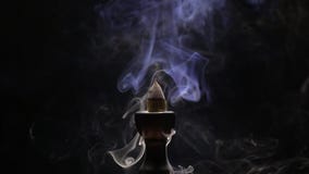 Aromatic cone smoldering in a ceramic stand