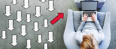 Arrow going in a different direction with man using a laptop stock image Arrow going in a different direction with man using a laptop stock image