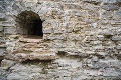 Arrowslit and limestone castle wall stock photo Arrowslit and limestone castle wall stock photo
